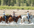 Children horse riding at wyoming ranch